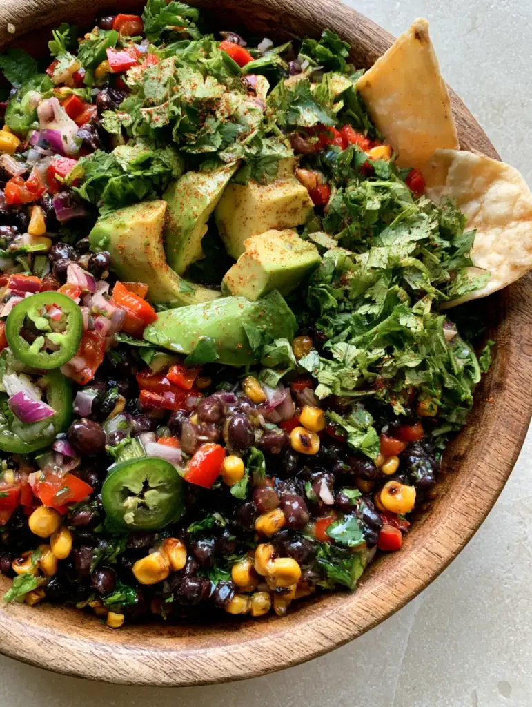 Cowboy Salad Recipe: The Ultimate Charred Corn and Black Bean Feast 1 Close up view of charred corn kernels and creamy avocado chunks in a Tex-Mex cowboy salad.