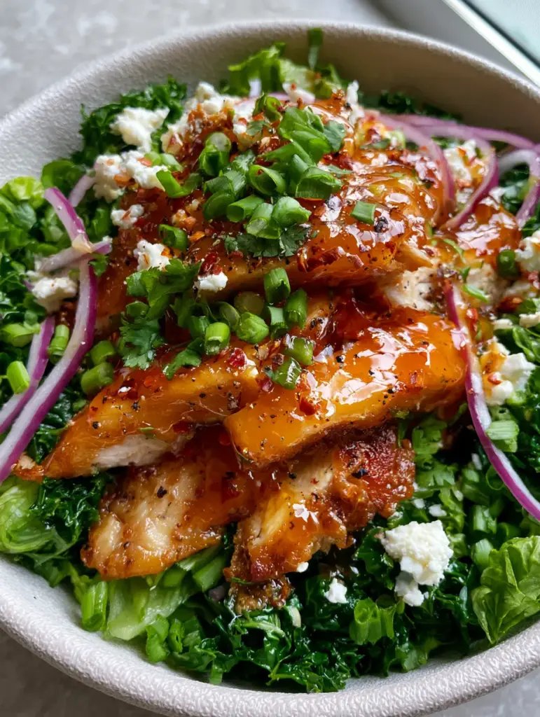 Honey Hot Chicken Salad with Glistening Amber Glaze and Massaged Kale 1 Overhead shot of Honey Hot Chicken Salad with purple onion slivers, feta cheese, and massaged kale foundation.